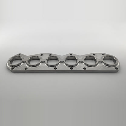 VR6 3.6L 24V exhaust manifold flange small port, tube side angled view showing recessed tube pockets and 16mm thickness, 304L stainless