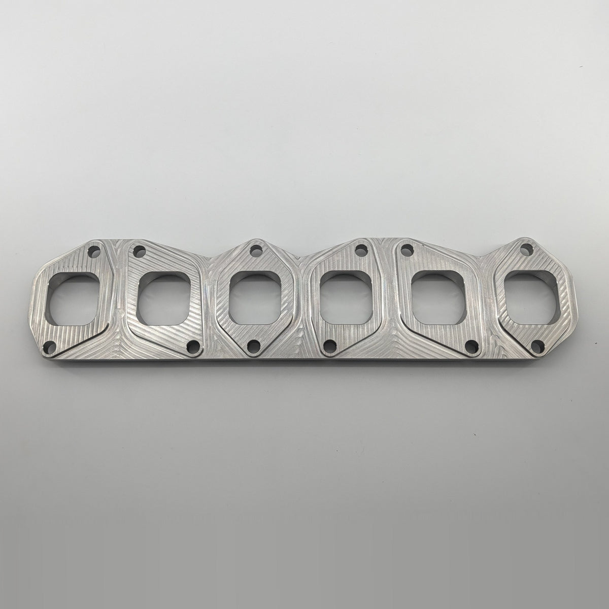 VR6 3.6L 24V exhaust manifold flange small port, manifold side top view showing D-shaped ports and bolt pattern, fits gasket 03H253050B