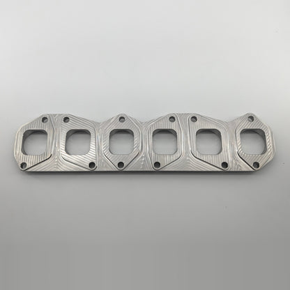 VR6 3.6L 24V exhaust manifold flange small port, manifold side top view showing D-shaped ports and bolt pattern, fits gasket 03H253050B