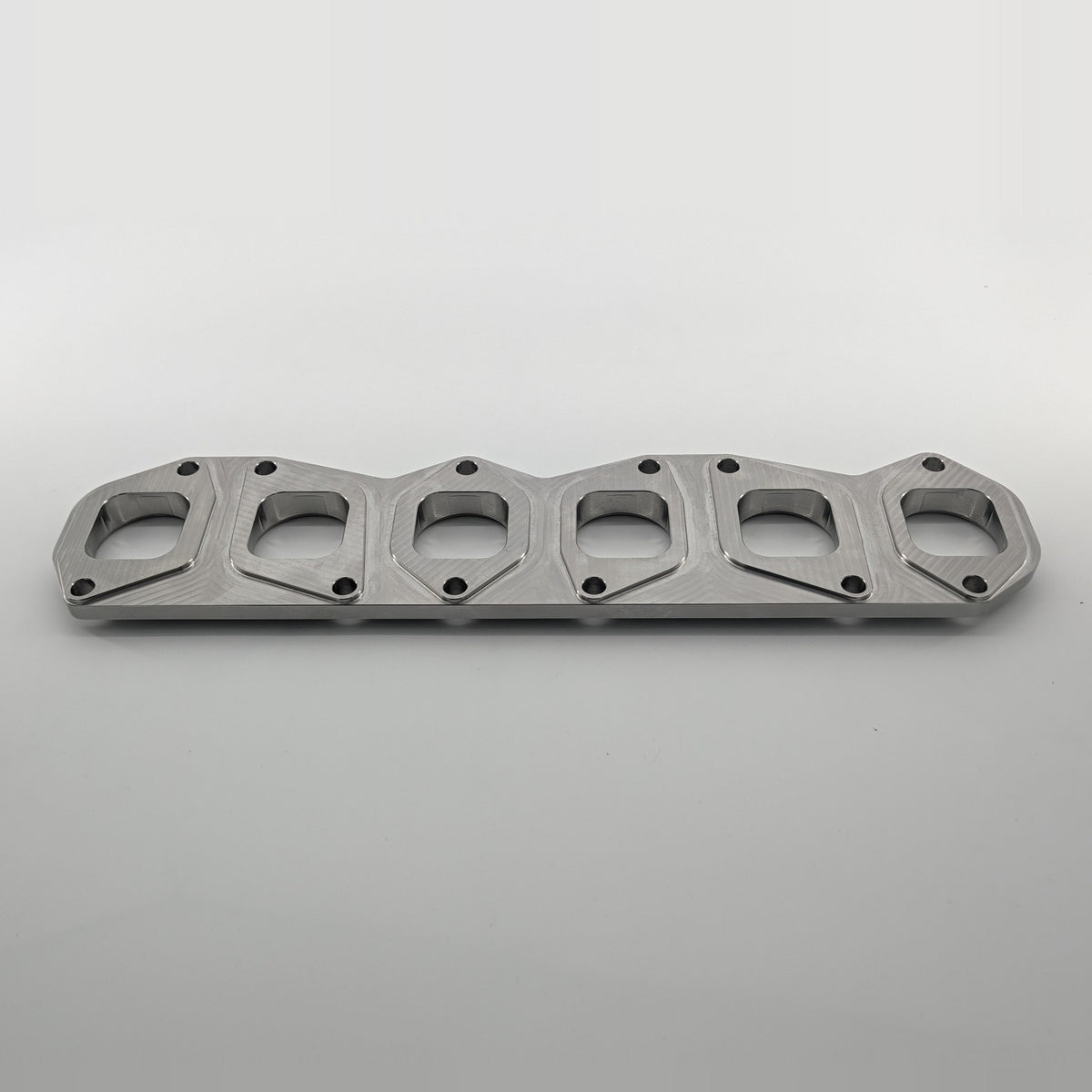 VR6 3.6L 24V exhaust manifold flange small port, manifold side angled view, square-to-round port transition, KMC Fabrication made in USA